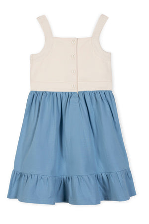 Organic cotton knit tank sundress featuring a cream bodice and a blue skirt with a flounce hem. Designed for ages 2T-12, this dress is perfect for playful summer adventures.