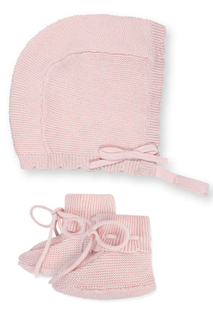 Pale pink organic cotton baby bonnet with rib trim and matching booties, crafted from soft sweater knit, ideal for keeping little ones cozy. Perfect for gifts or heirloom collections.