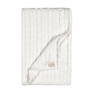 A soft, cream-colored knitted blanket featuring a textured cable pattern. This cozy blanket is perfect for infants, made from organic materials for gentle comfort against delicate skin.