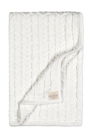 A soft white organic cotton cable knit baby blanket features a chunky pattern, perfect for strollers and outings. This heirloom-quality piece is ideal for gifting or personal use.