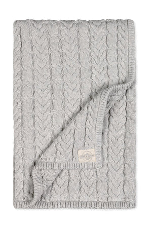 A light gray organic cotton cable knit baby blanket features a chunky design, perfect for cozy cuddles and outdoor outings. The blanket is soft, sustainable, and ideal for infants.