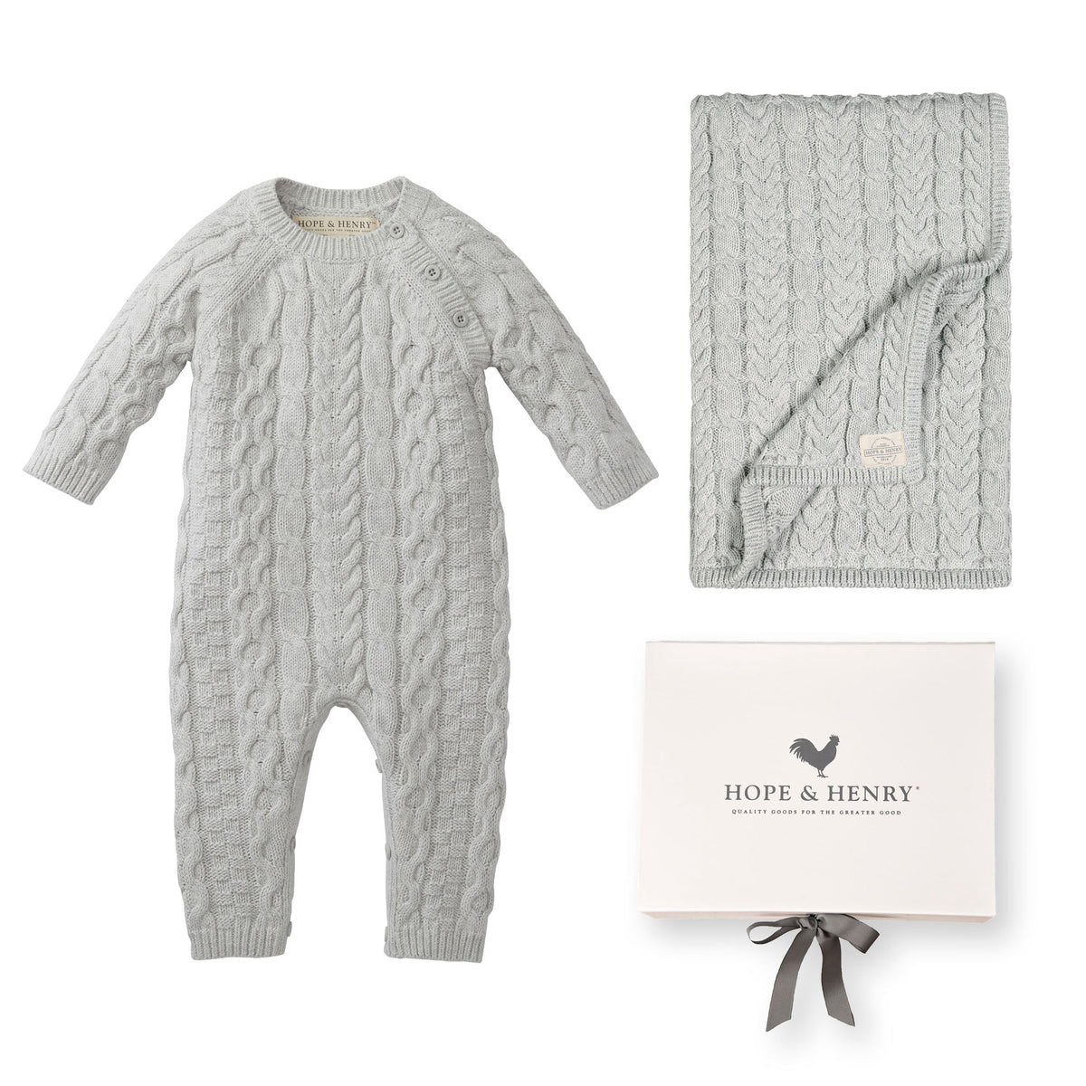 Light gray cable-knit romper and matching blanket from Hope & Henry, presented in a stylish gift box. Made from GOTS certified organic cotton, perfect for delicate baby skin.