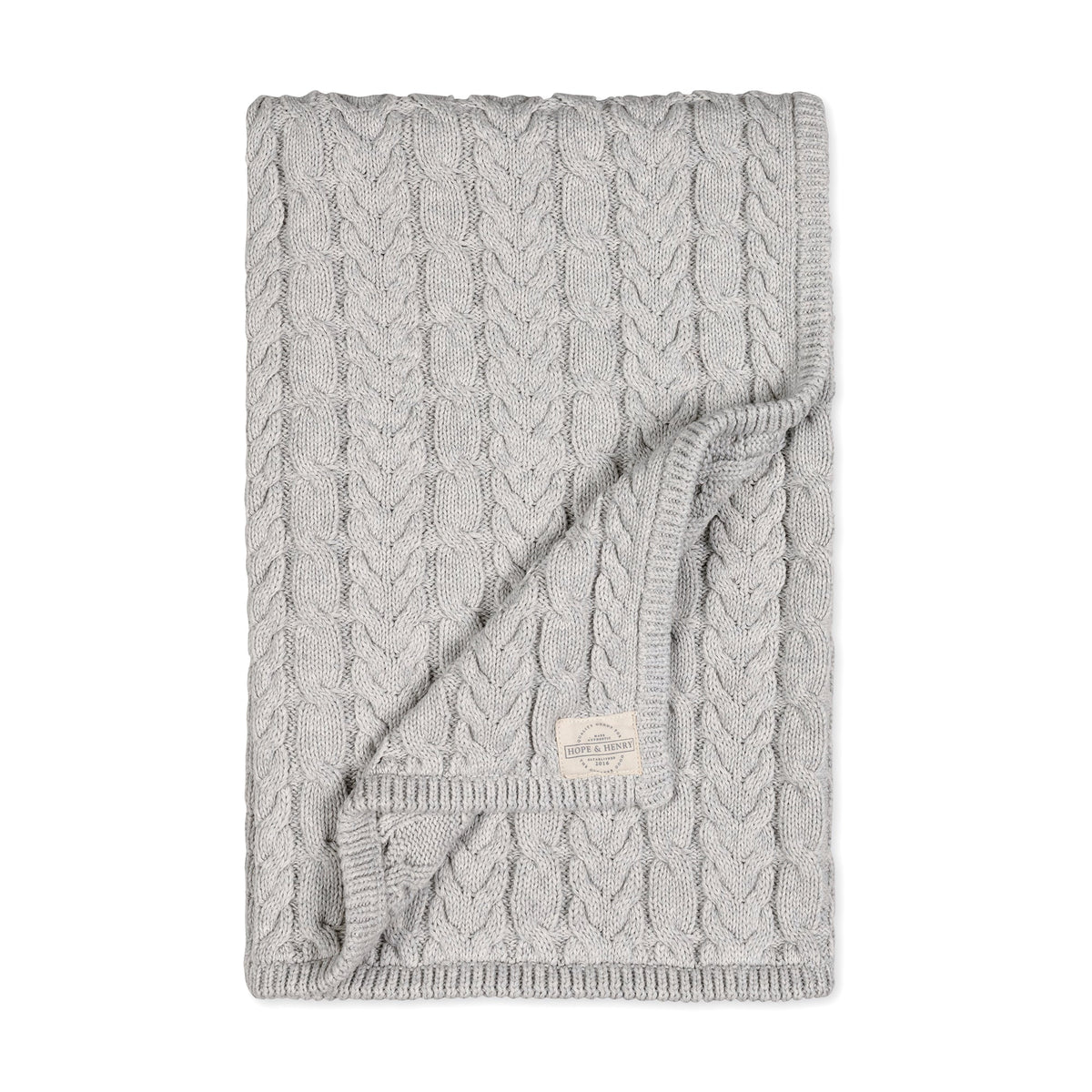 Light gray blanket featuring a classic cable knit design, made from GOTS certified organic cotton. This cozy, breathable fabric is perfect for keeping babies comfortable.