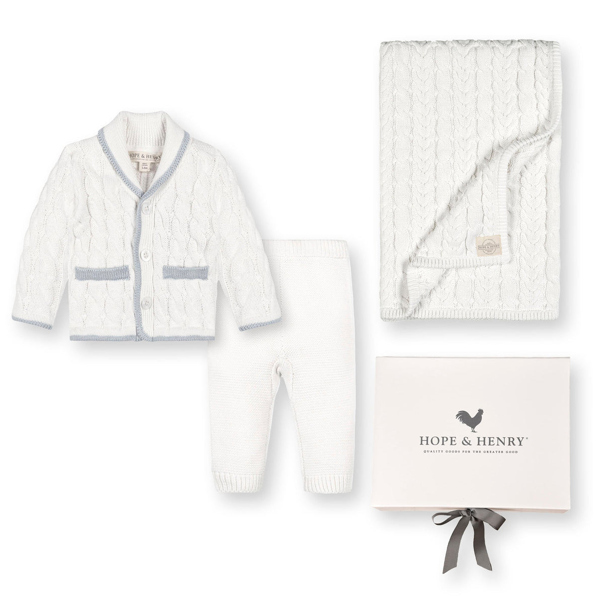 A cozy three-piece gift set featuring a white cable-knit cardigan with a shawl collar, matching leggings, and a soft blanket, all beautifully presented in a box from Hope & Henry.