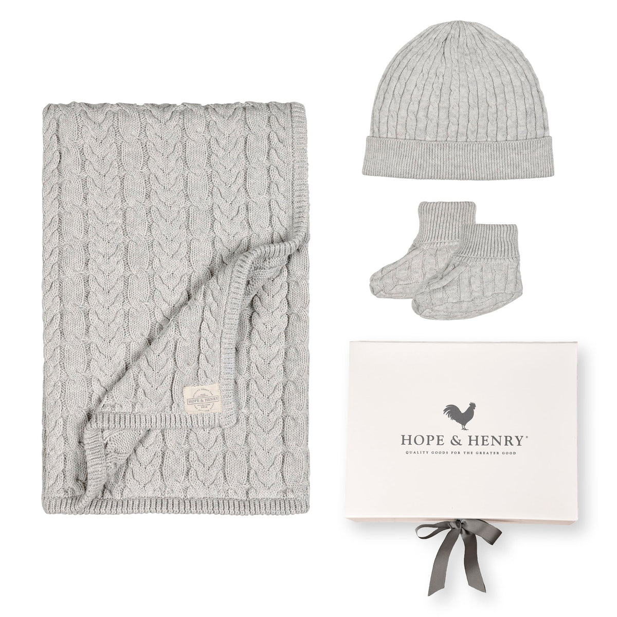 Light gray heather baby gift set featuring a cozy cable knit blanket, matching beanie, and booties. Made from GOTS certified organic cotton, perfect for everyday comfort and cuddles.