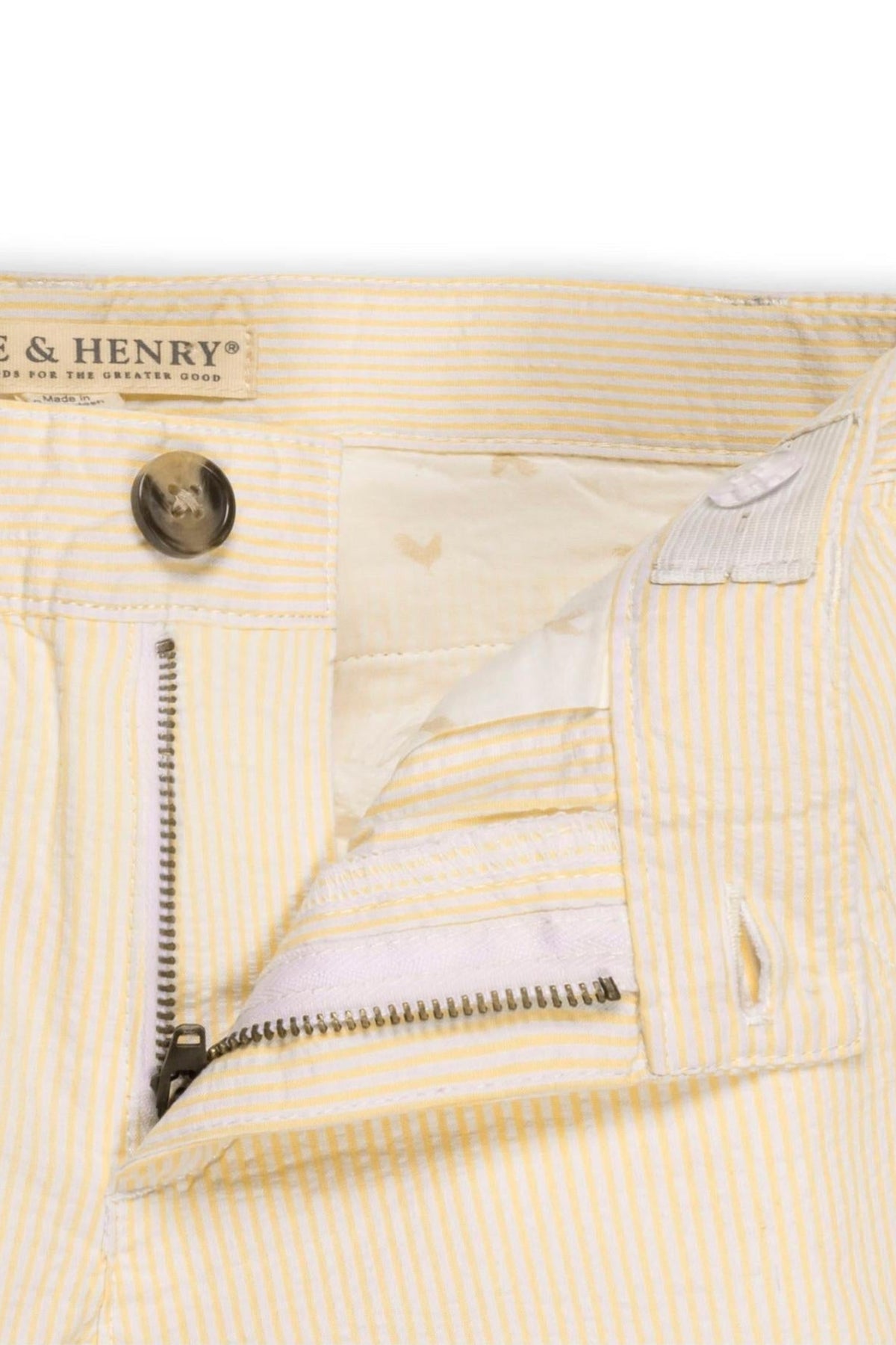 Close-up view of Hope & Henry organic cotton seersucker shorts for boys, featuring a yellow and white striped pattern.