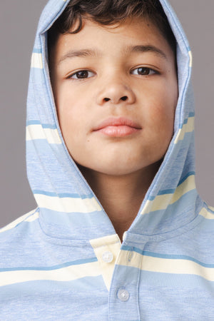 A young boy models a light blue hoodie with yellow and white stripes and a cozy hood. The hoodie features a Henley button placket, perfect for a stylish, casual look.
