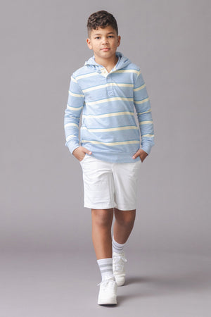 A child walks confidently in a light blue striped hoodie with a cozy hood and Henley button placket, paired with white shorts and sneakers, set against a neutral background.