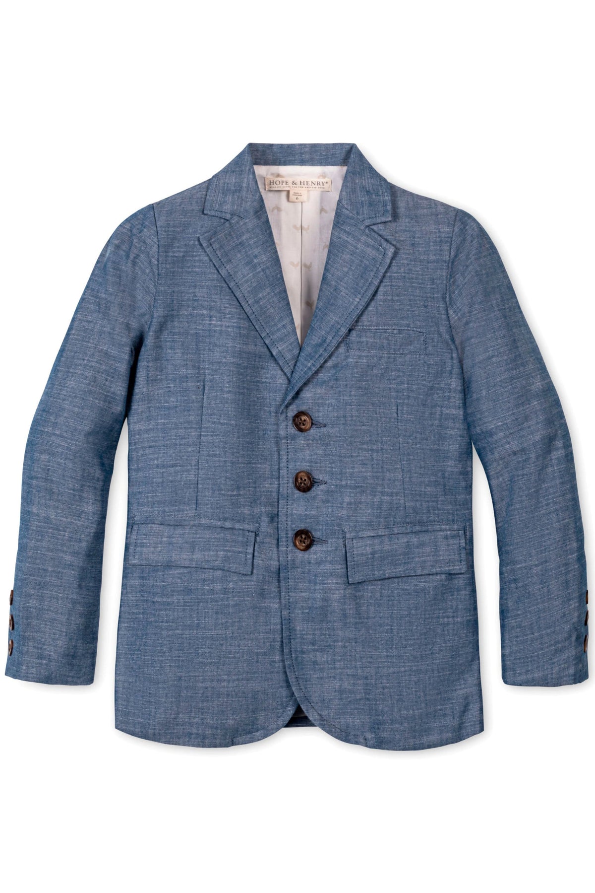Blue chambray suit jacket for boys with faux horn buttons and flap pockets, made from organic cotton.
