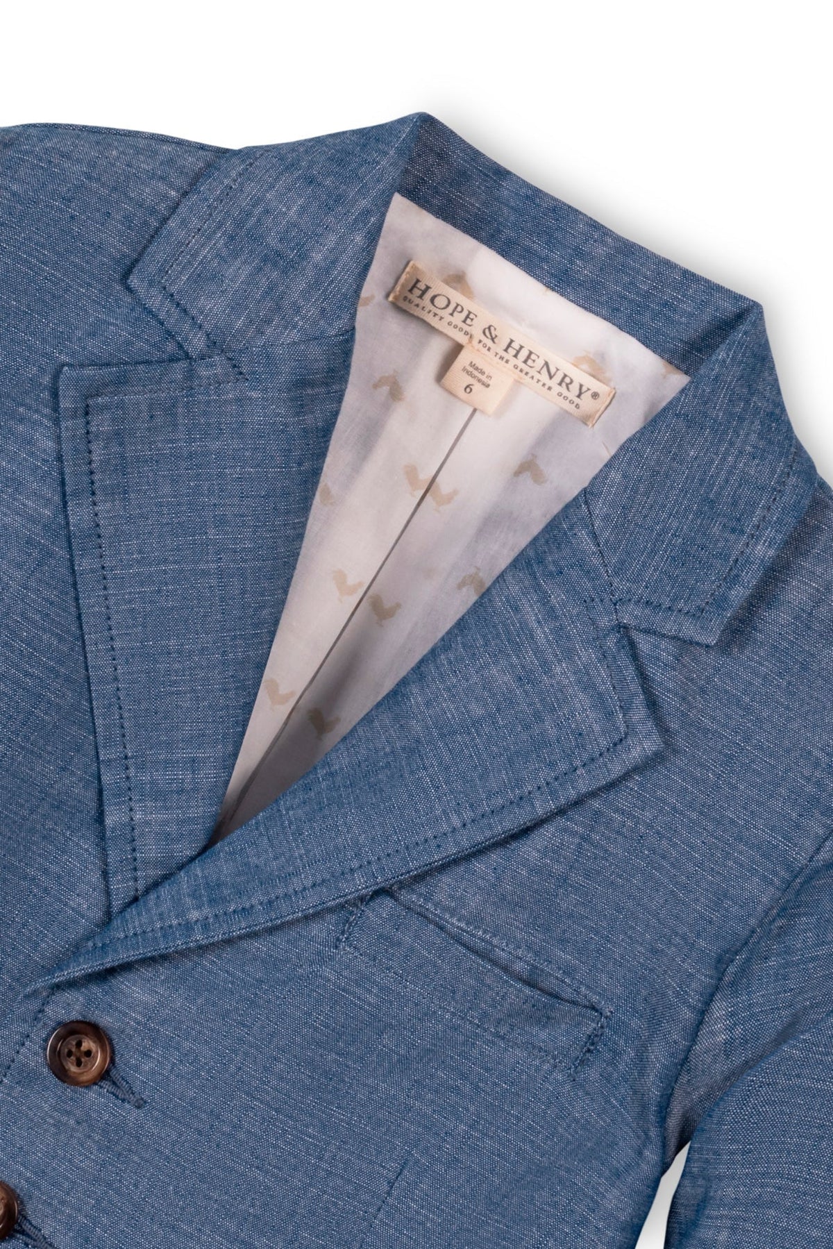 Blue chambray suit jacket with faux horn buttons and flap pockets, featuring a Hope & Henry label inside.