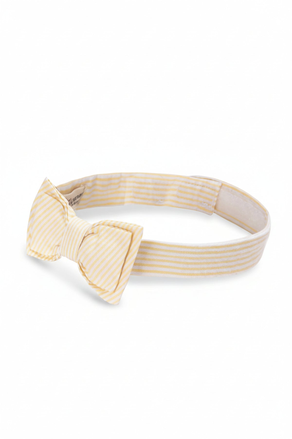 A yellow seersucker bow tie features a double bow and striped pattern, perfect for formal outfits. Made from organic cotton.