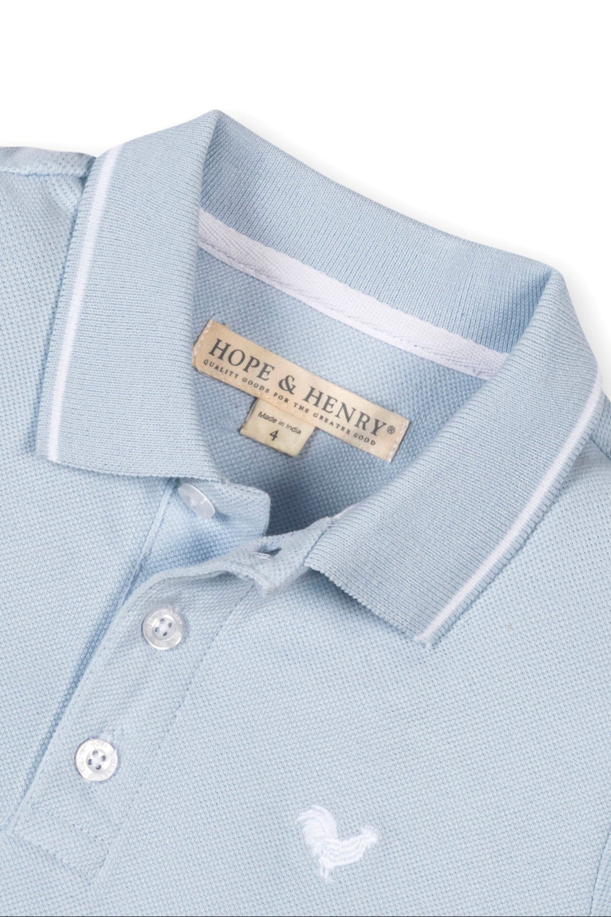 Close-up of a light blue organic cotton polo shirt by Hope & Henry, featuring a flat-knit collar and button placket.