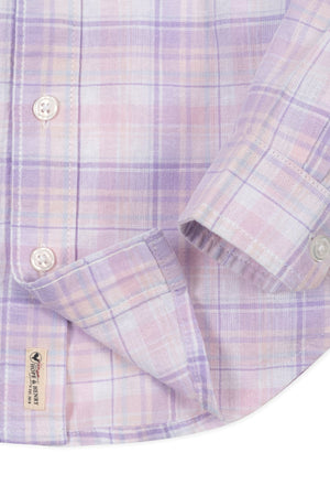 Close-up of a light plaid button-down shirt in lavender and pastel colors, featuring a chest pocket and branded label.