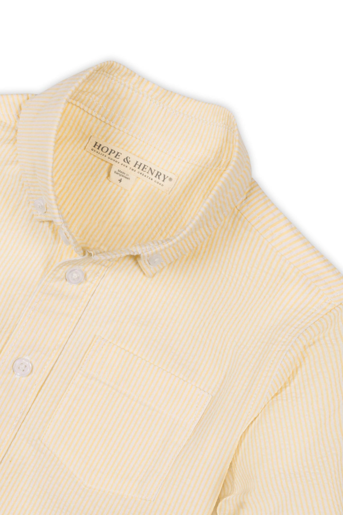 Close-up of a yellow and white striped Hope & Henry organic cotton shirt featuring a collar, buttons, and a chest.