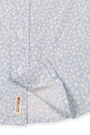 Light blue short sleeve shirt featuring a subtle floral pattern, button closure, and a functional chest pocket.