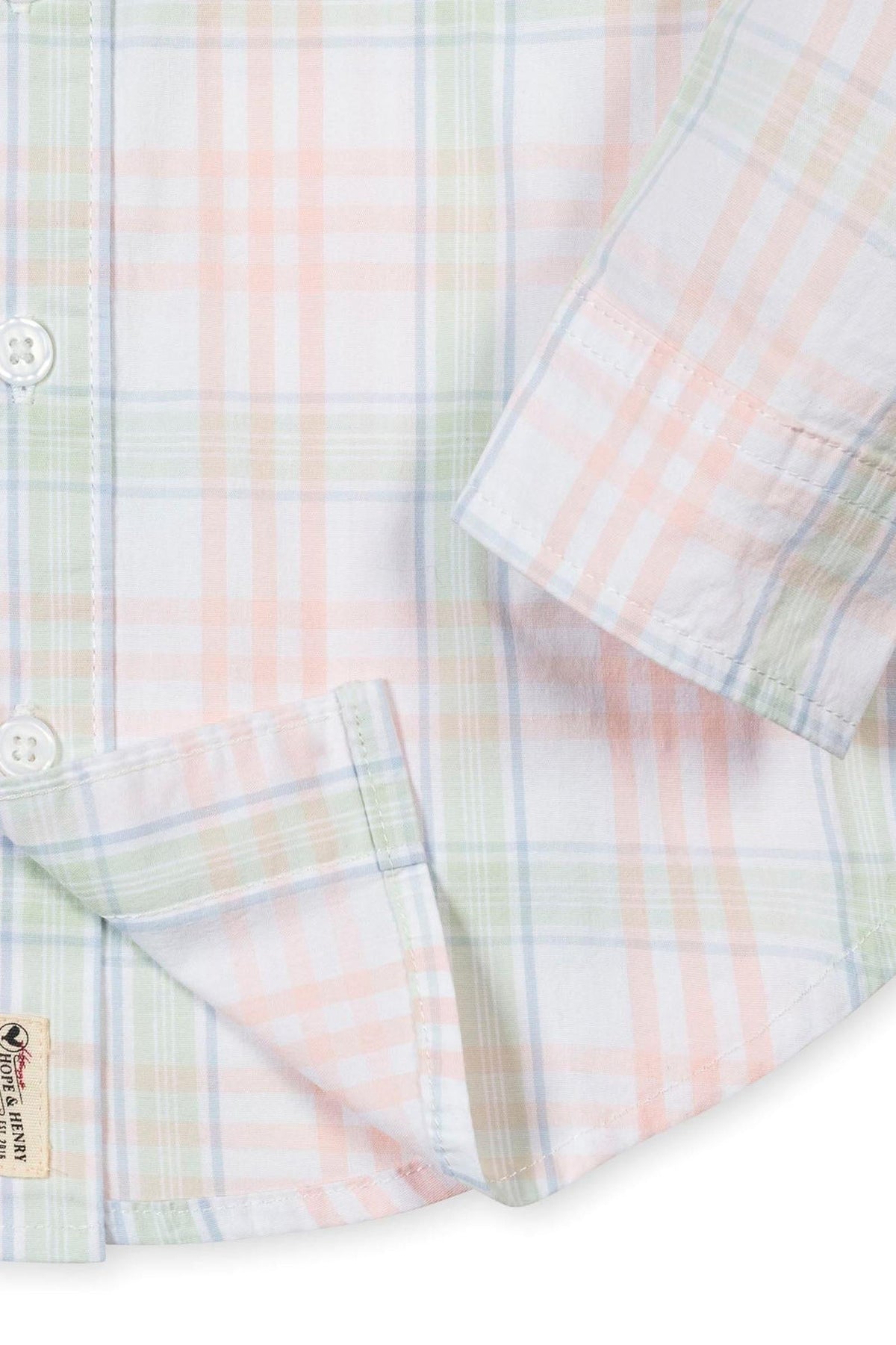 Close-up of a Hope & Henry organic cotton shirt featuring a soft plaid pattern in pastel colors, with a button-down.