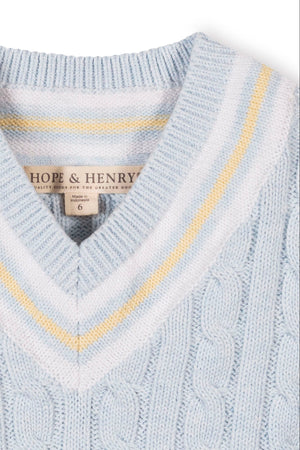 Light blue organic cotton cricket sweater vest featuring a v-neck and contrasting yellow stripe trim. Ideal for boys, sizes 2T-18.
