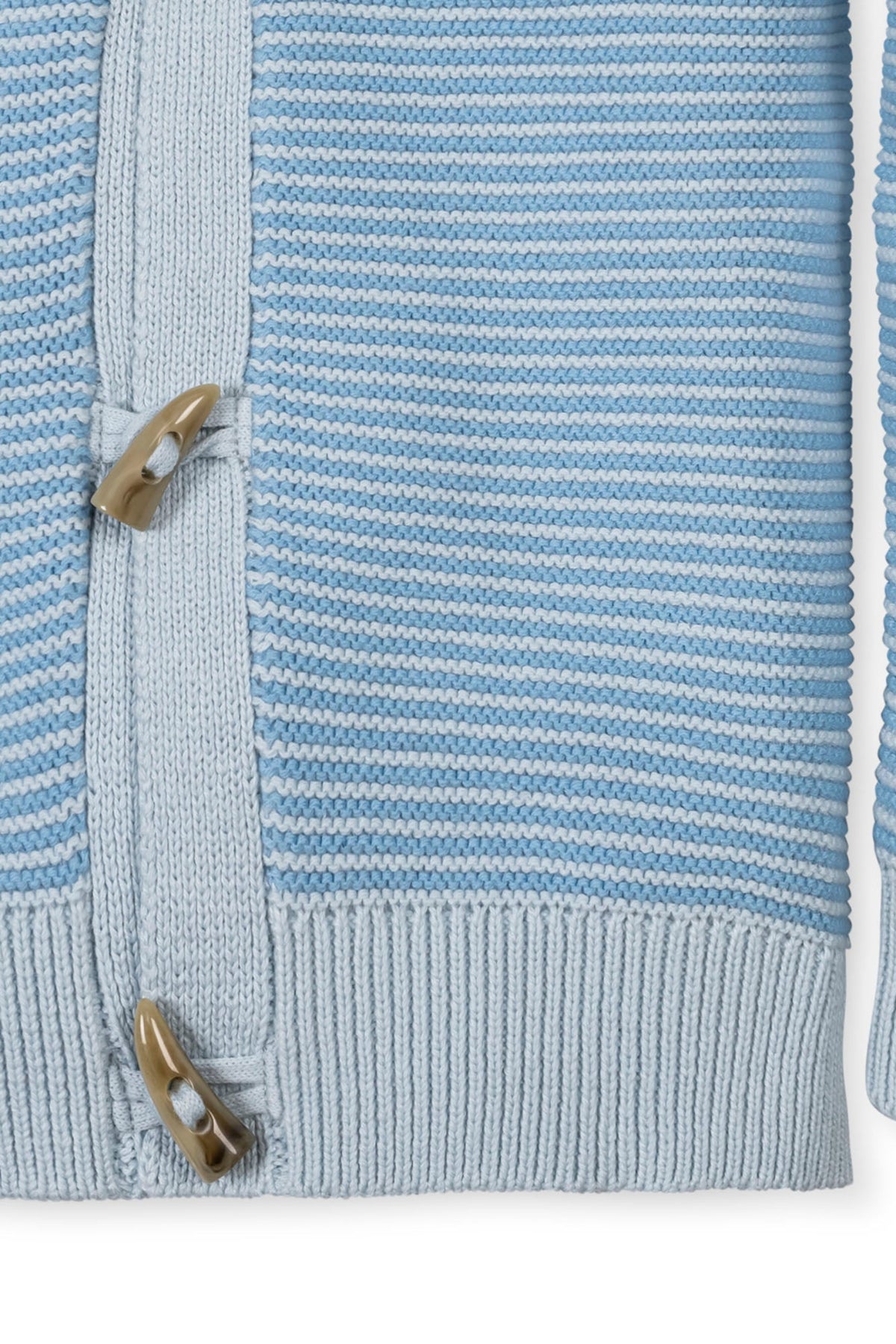 Close-up of a light blue striped cardigan featuring a shawl collar and toggle closure, made from soft organic cotton.