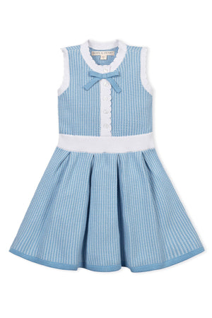 Blue and white sleeveless dress with button front, scalloped edges, and a bow at the neckline.