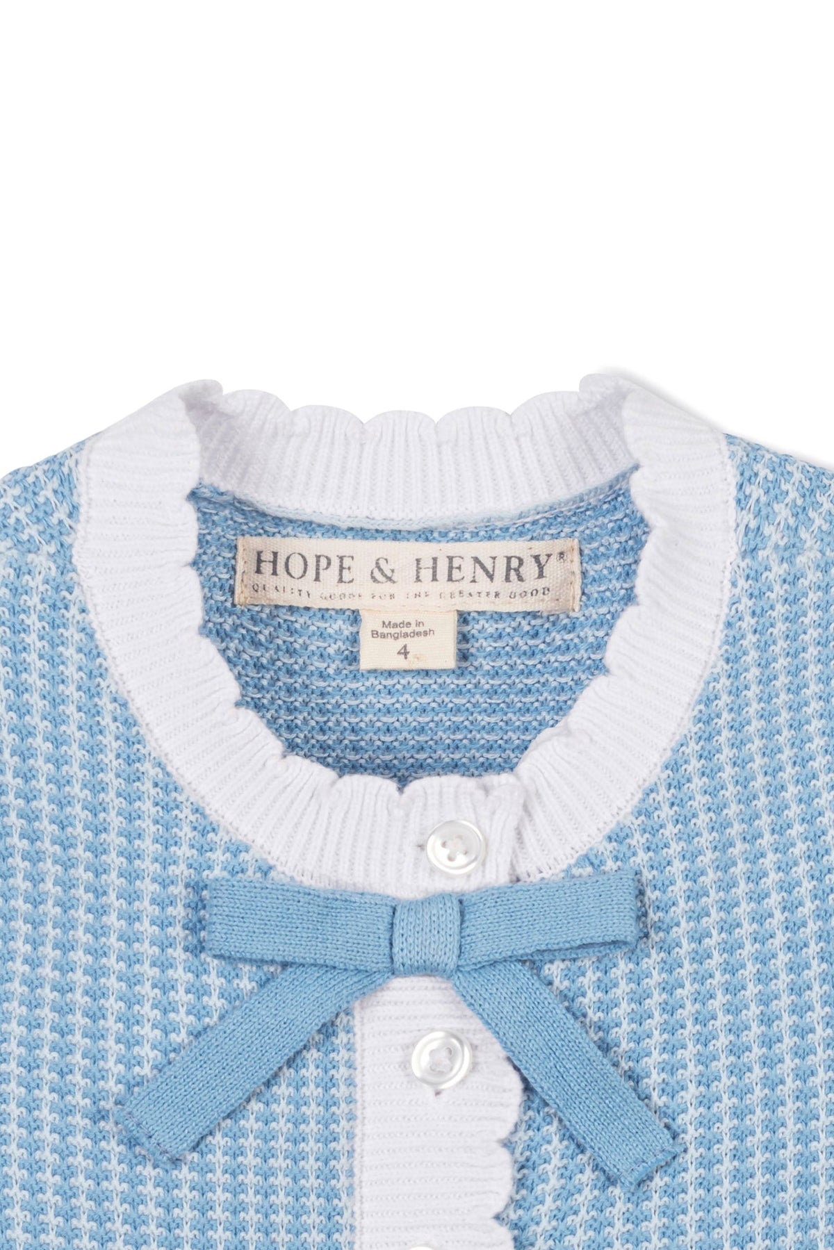Close-up of a blue Hope & Henry sweater dress with a white scalloped collar and a decorative bow.