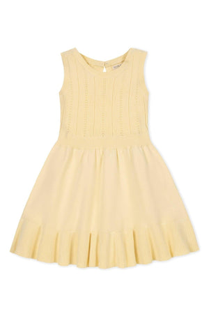 Yellow tank sweater dress with a flounce hem and textured bodice, made of organic cotton.