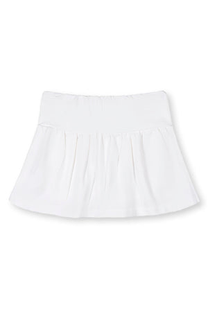 White organic cotton skort featuring a flouncy skirt and elastic back waist. Ideal for children, this soft French terry skort combines comfort and style for active play.