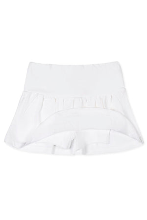 White organic cotton skort featuring a flouncy skirt and an elastic back waist. Designed for comfort and play, it’s suitable for children ages 2T to 12.
