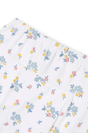 Close-up of a white skort featuring a colorful floral print in soft blue, yellow, and pink hues. Made from organic cotton, it has an elastic waistband for comfort and ease.