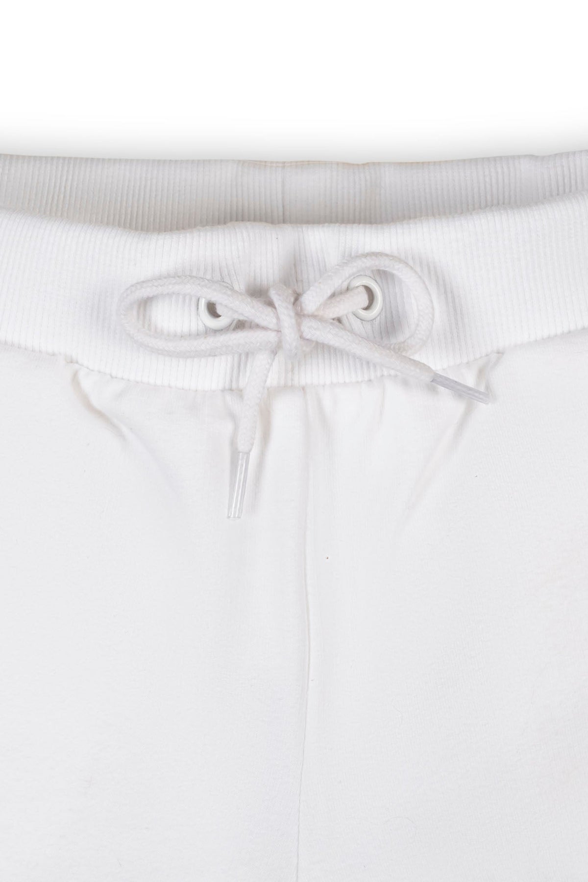 Close-up of white organic cotton French terry shorts featuring an elastic waistband and faux drawcord. The soft fabric is designed for comfort, suitable for toddlers and kids.