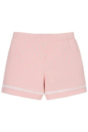 Light pink seersucker shorts featuring white ladder trim and side pockets, made from soft organic cotton for girls.