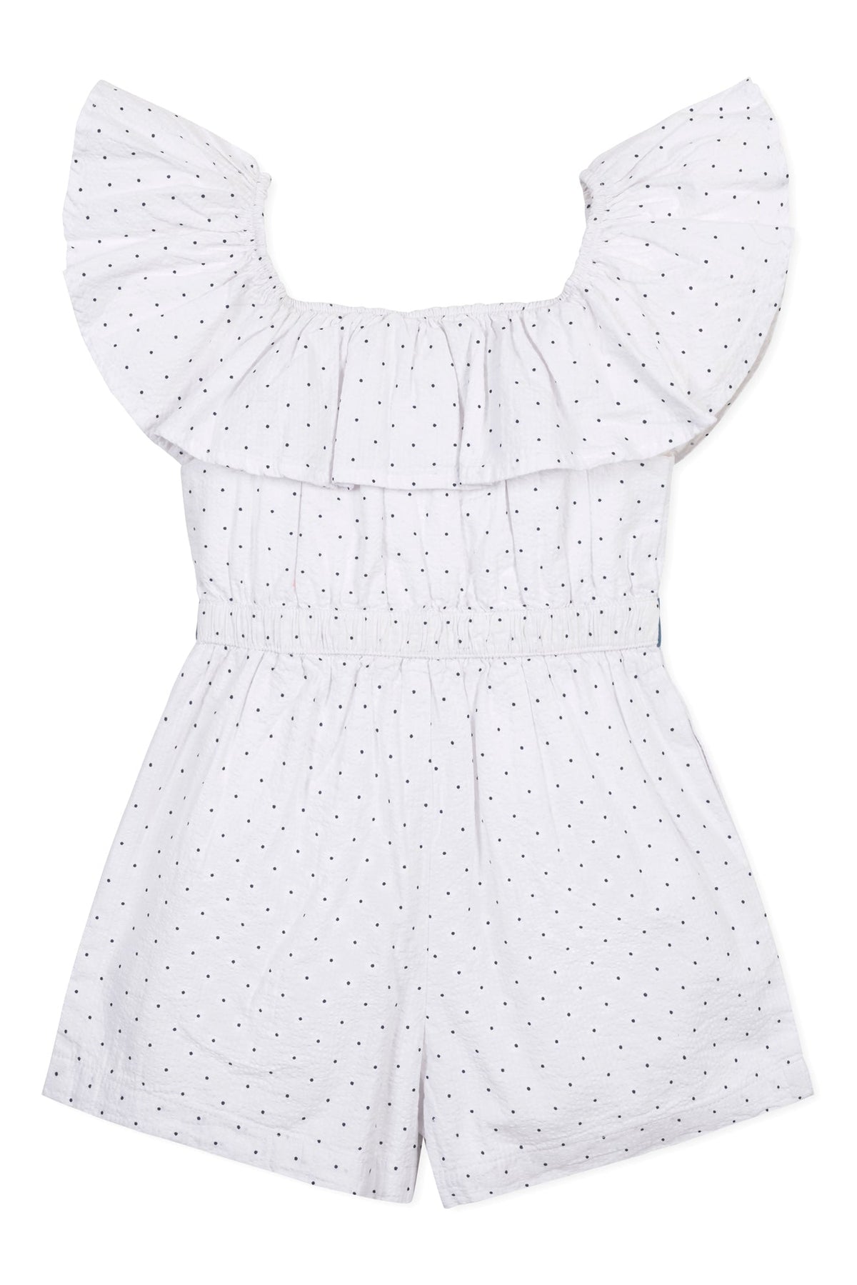 A white organic cotton seersucker romper features a ruffle collar and black dot patterns. Designed for toddlers and kids.