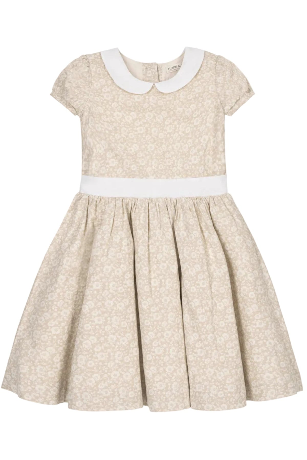 A sandy floral dress by Hope & Henry features a Peter Pan collar, puff sleeves, and a pleated waist sash.