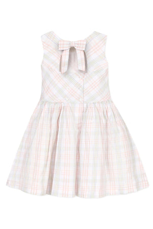 A sleeveless toddler dress in soft pastel plaid, featuring a bow at the back and a button closure.