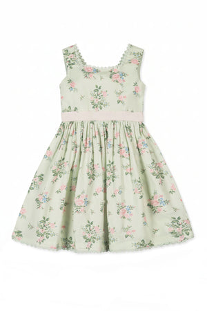 A sleeveless dress in soft green fabric features a floral pattern with pink and blue flowers, and a crochet-trimmed neckline.