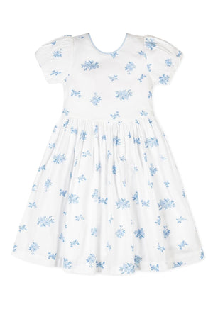 White dress featuring delicate blue floral patterns and puff sleeves, made from soft organic cotton. Ideal for girls special occasions.