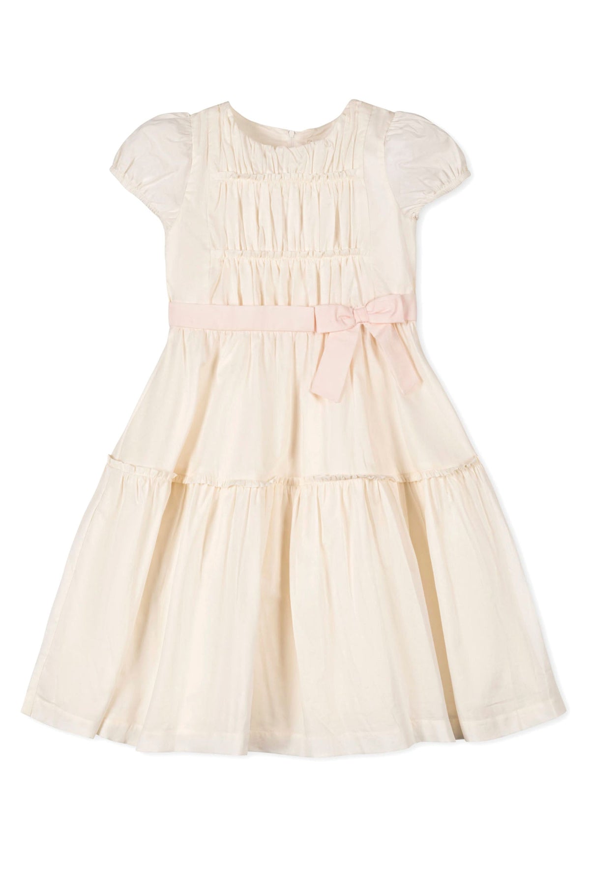 Natural-colored girls dress with puff sleeves, pink waist sash, and tiered skirt made from organic cotton.