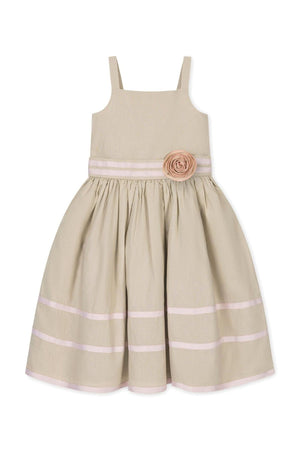 A soft sand-colored linen cami dress features a fit and flare silhouette, ribbon trim, and a decorative rosette at the waist, perfect for toddlers and kids. Ideal for spring occasions.