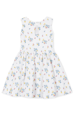White tank dress featuring a floral pattern in pastel colors, made from soft organic cotton with a twirly skirt.