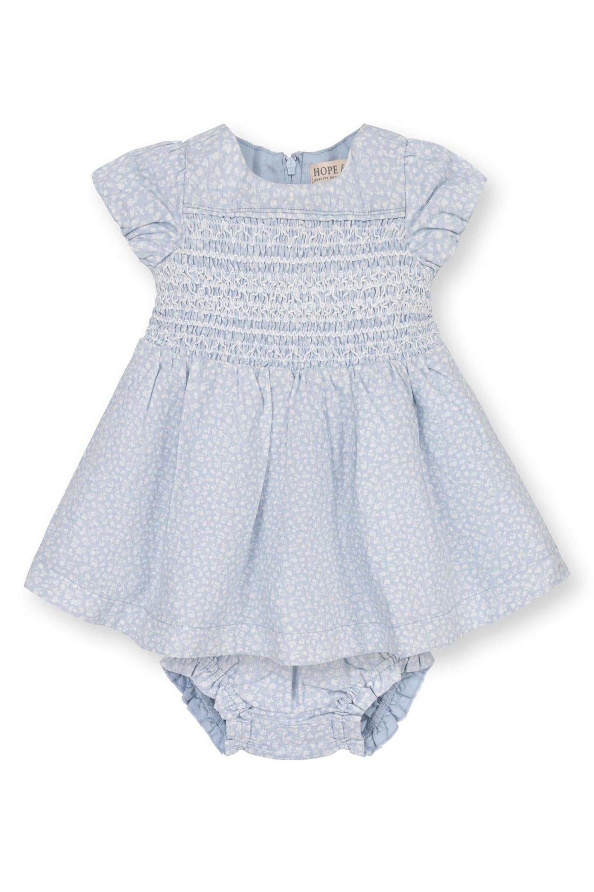 Light blue smocked baby dress with puff sleeves and matching diaper cover, featuring a subtle white floral pattern.