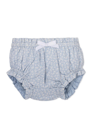 Light blue baby diaper cover with white floral pattern, ruffled edges, and a small white bow at the front.