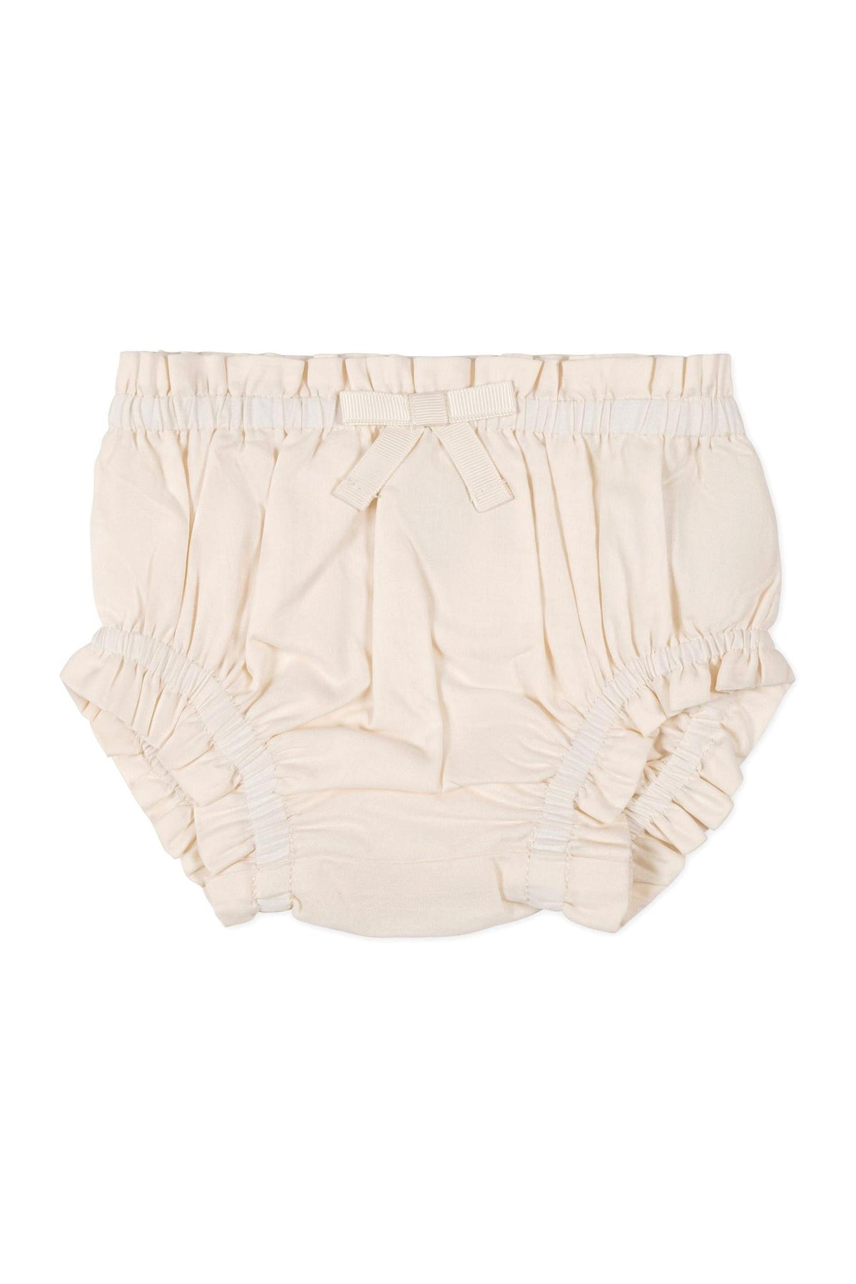 Beige organic cotton diaper cover with ruffled edges and a decorative bow at the waist, designed for babies.
