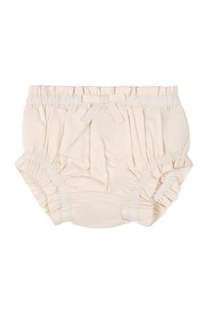 Beige organic cotton diaper cover with ruffled edges and a decorative bow at the waist, designed for babies.