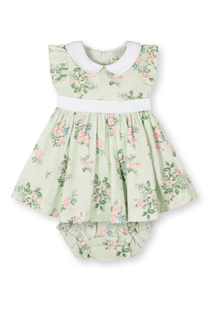 Light green floral dress with a white Peter Pan collar, flutter sleeves, and matching diaper cover, made from organic cotton.