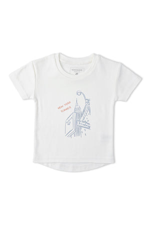 White organic cotton graphic tee featuring a New York skyline design, with playful illustrations and the text NEW YORK in red. Ideal for stylish, eco-conscious children.