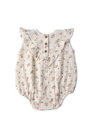 Organic sleeveless ruffle bubble romper in blush floral features soft, breathable fabric, whimsical patterns, and easy snap closures. Ideal for keeping little ones cool and comfortable during playtime.