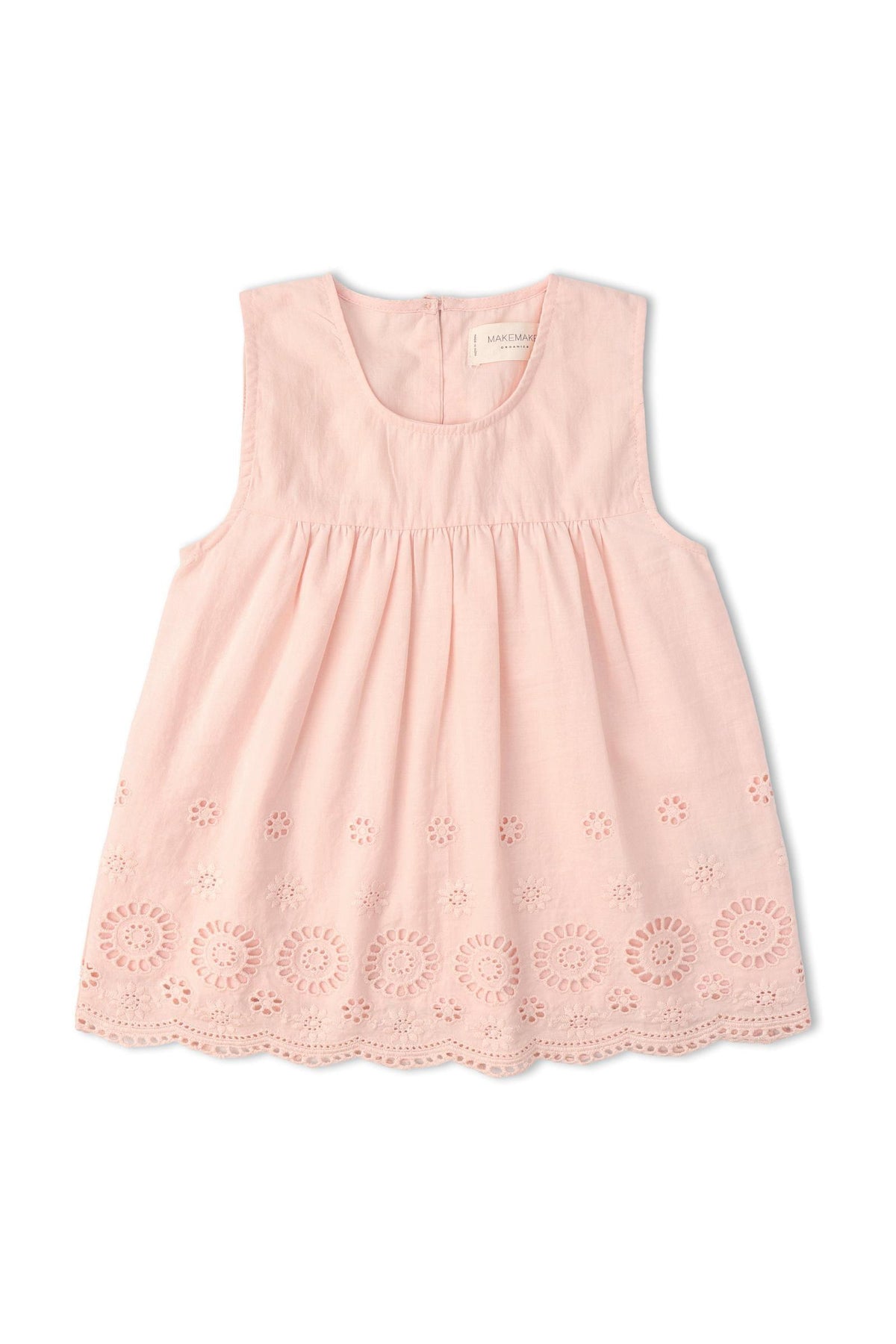 A soft pink sleeveless top features delicate eyelet detailing along the hem. Crafted from organic cotton, this breezy piece is perfect for warm-weather outings and celebrations.