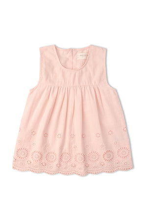 A soft pink sleeveless top features delicate eyelet detailing along the hem. Crafted from organic cotton, this breezy piece is perfect for warm-weather outings and celebrations.