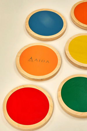 A set of six colorful stepping stones in blue, orange, yellow, red, and green, each with smooth wooden edges, designed for childrens balance and coordination play. Ideal for imaginative activities.