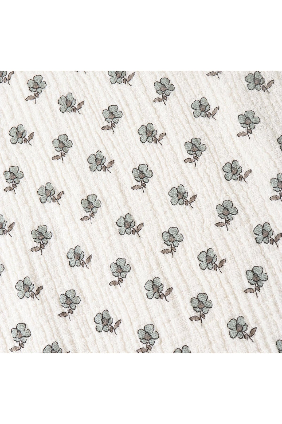 A close-up view of a textured fabric featuring a repeated pattern of light green cotton plants outlined in brown. The material appears soft and is likely made from organic cotton.