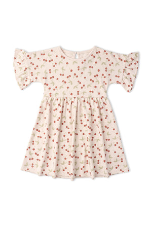 Light pink organic cotton dress featuring a playful cherry print and relaxed dolman sleeves, perfect for everyday wear. This dress combines comfort and style for children.